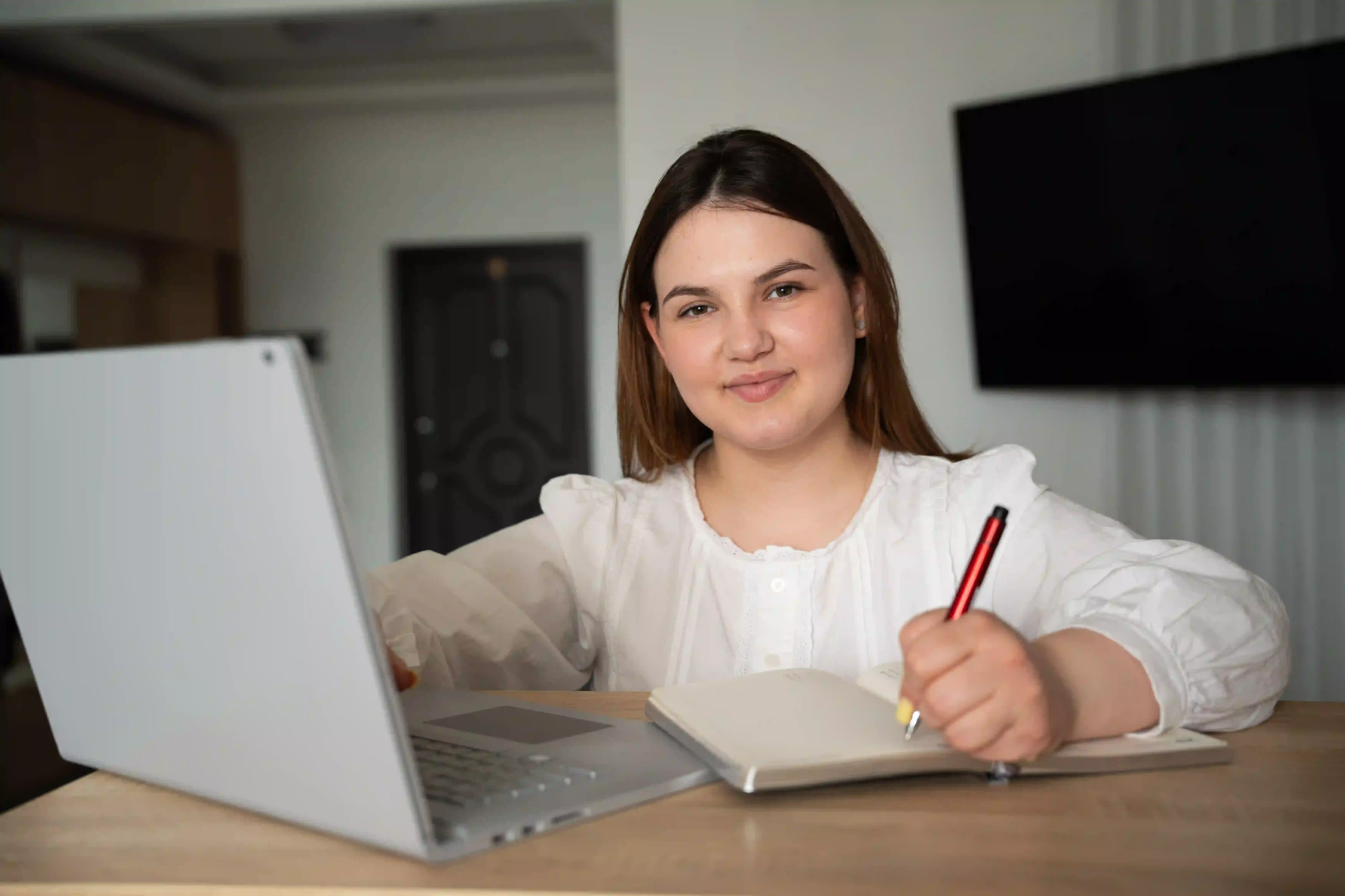 A student in Canada attending an online business studies tutoring session on a laptop