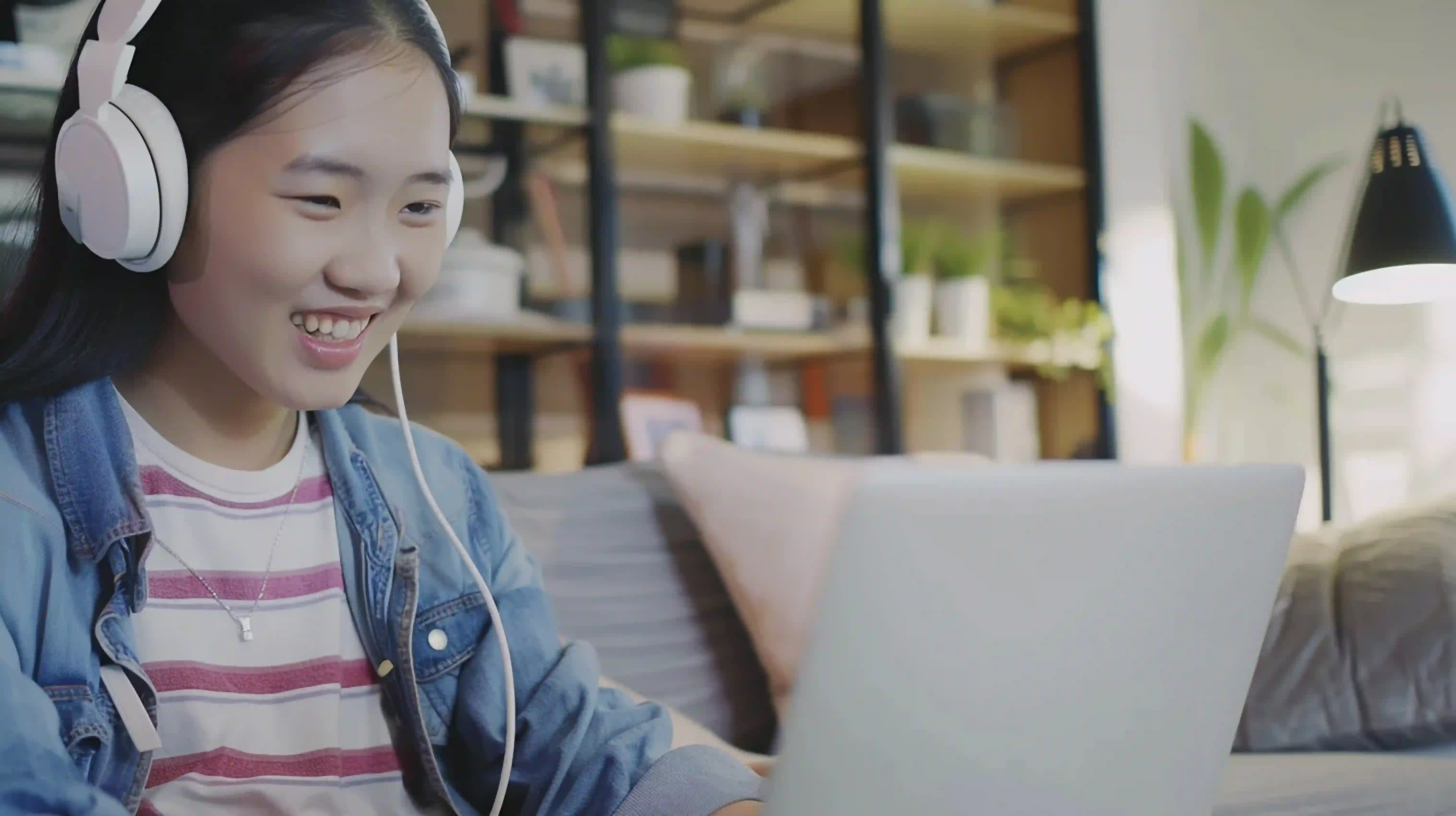 A Singapore student studying with a laptop during an online Biology tutoring session