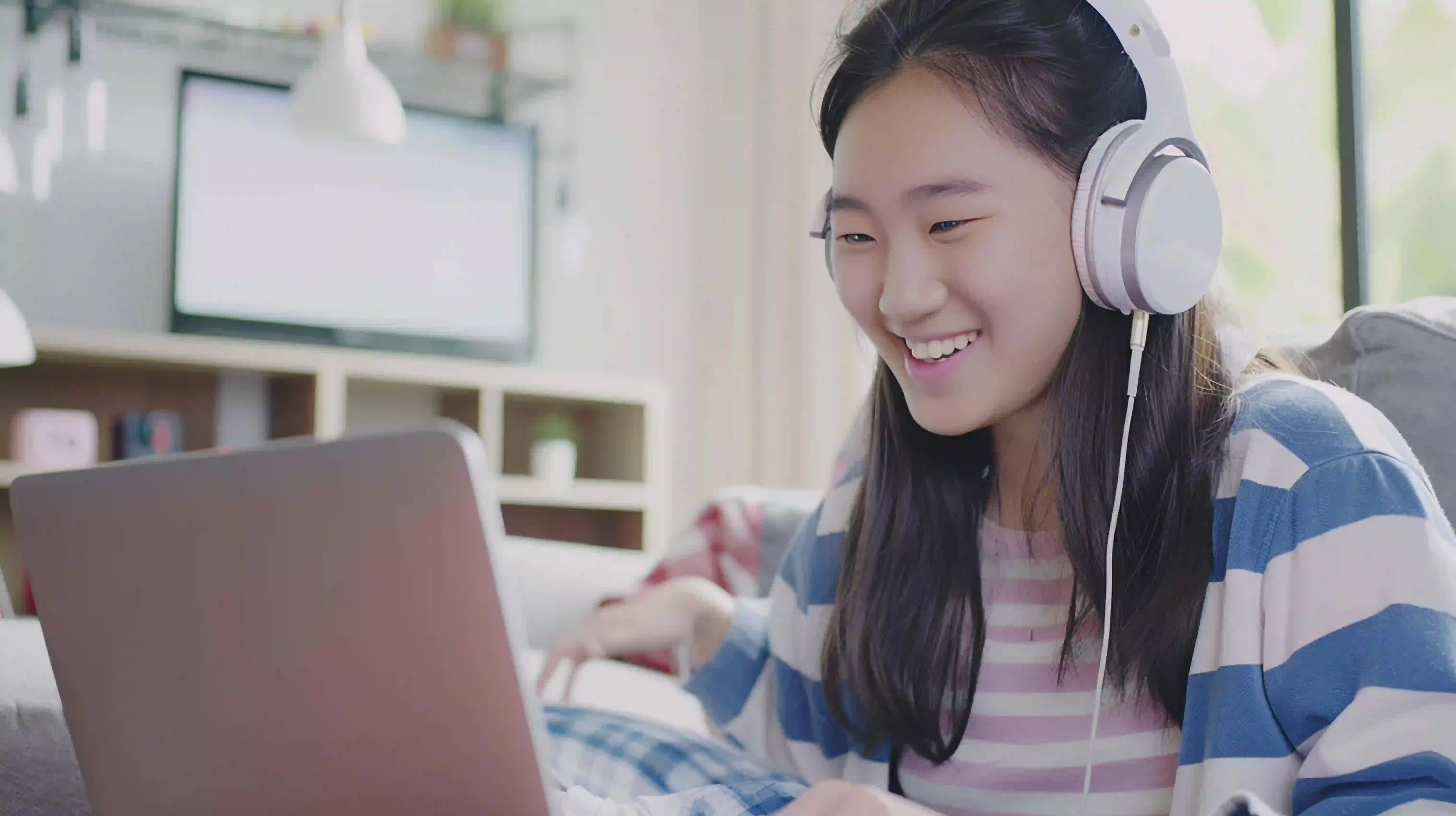 A Singapore student studying with a laptop during an online Chemistry tutoring session